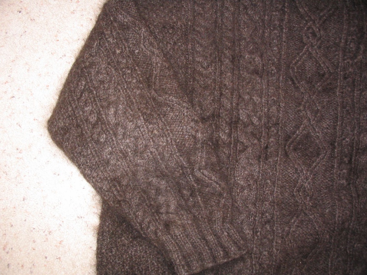 A close-up of cable knitting on a wool sweater