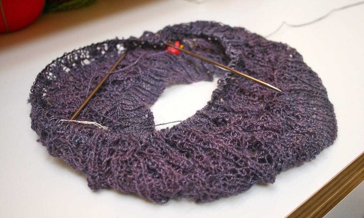 A knitted hat body in progress before the crown shaping
