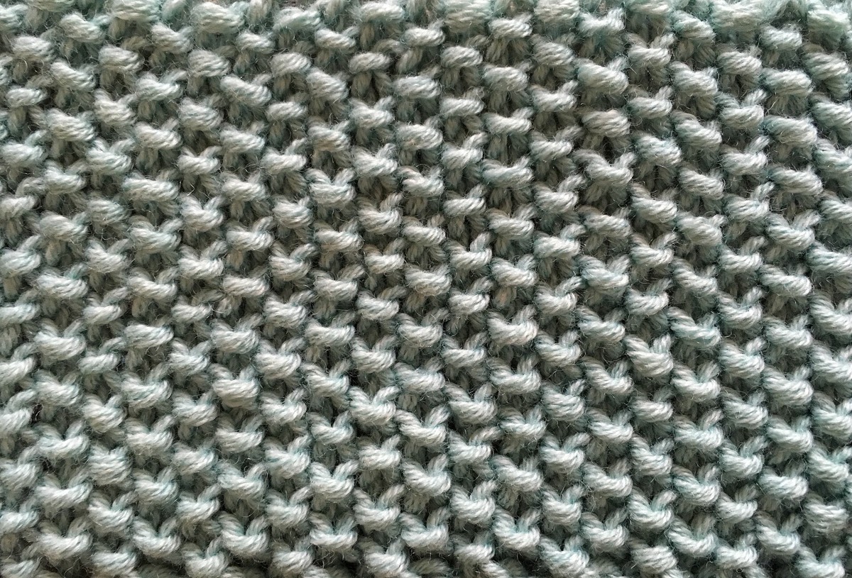 A moss-stitch swatch in cream yarn