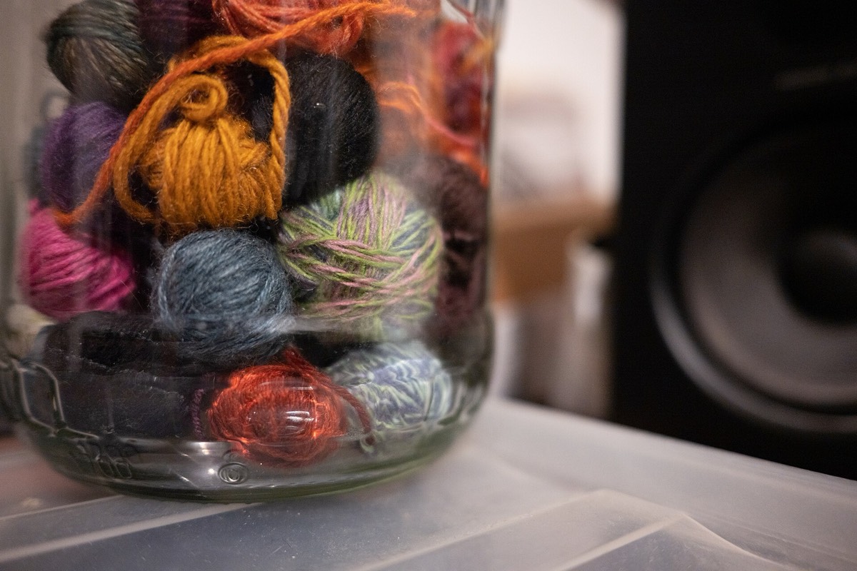 A jar filled with cream wool yarn