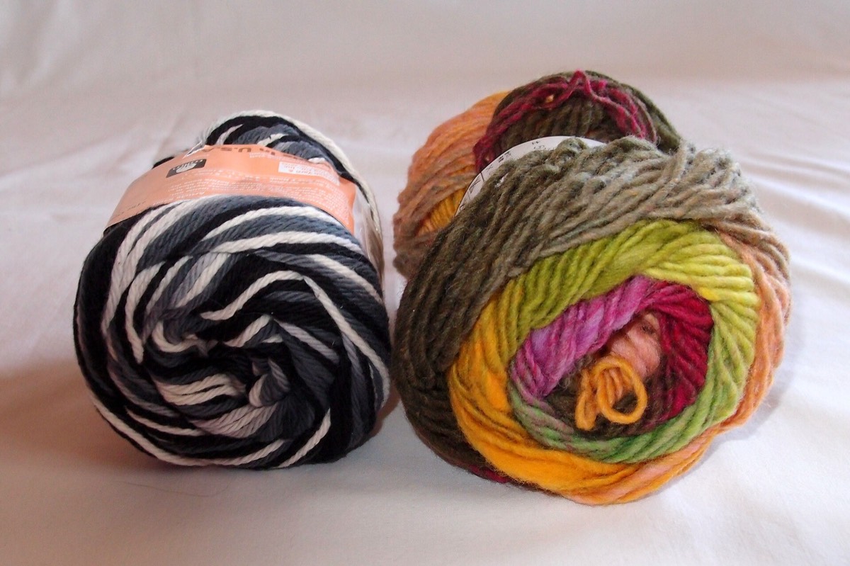 Two skeins of yarn side by side, cotton on the left and wool on the right